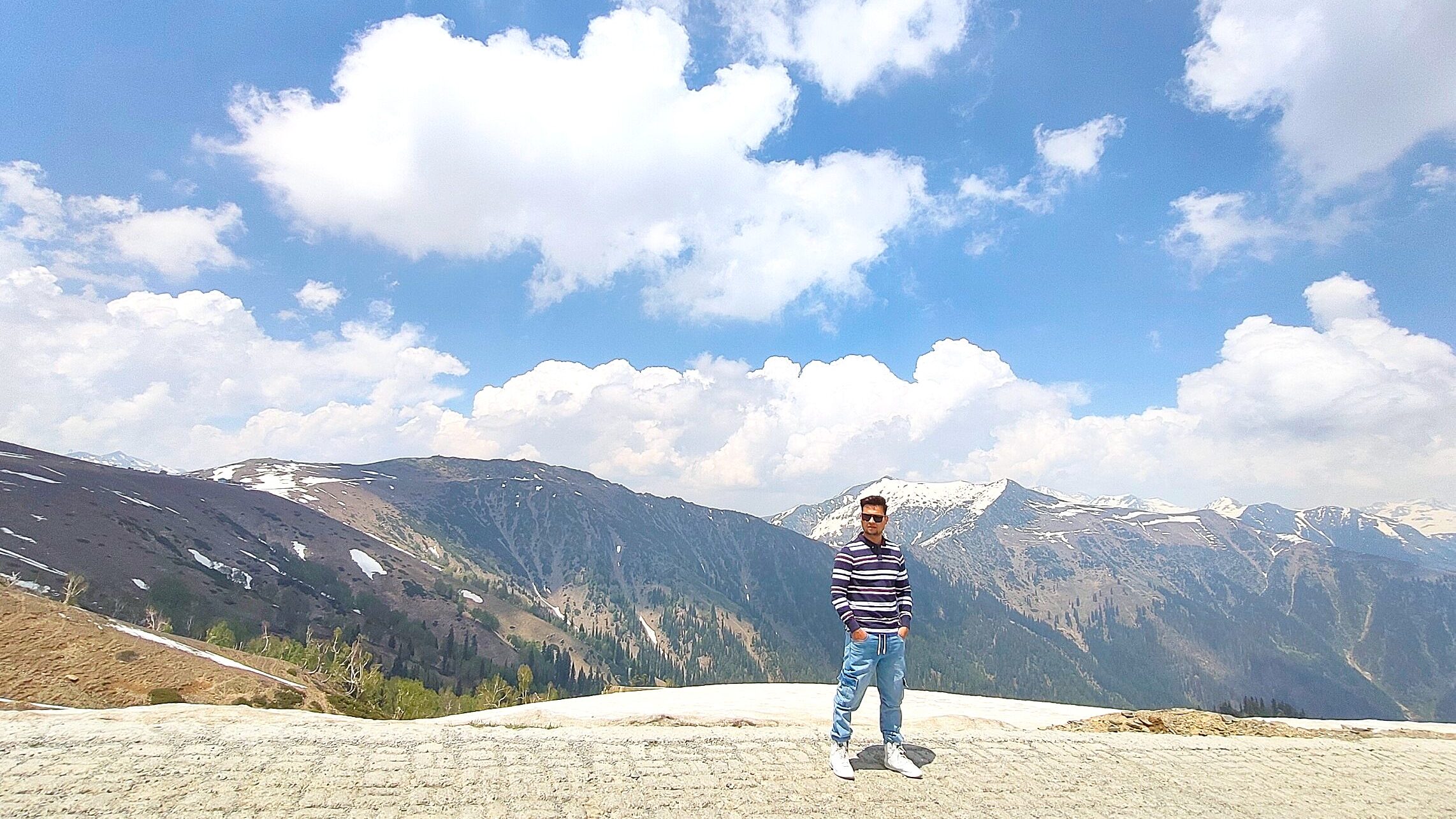 Scenic view from Razdan Pass with snow-covered peaks and high-altitude roads in Kashmir