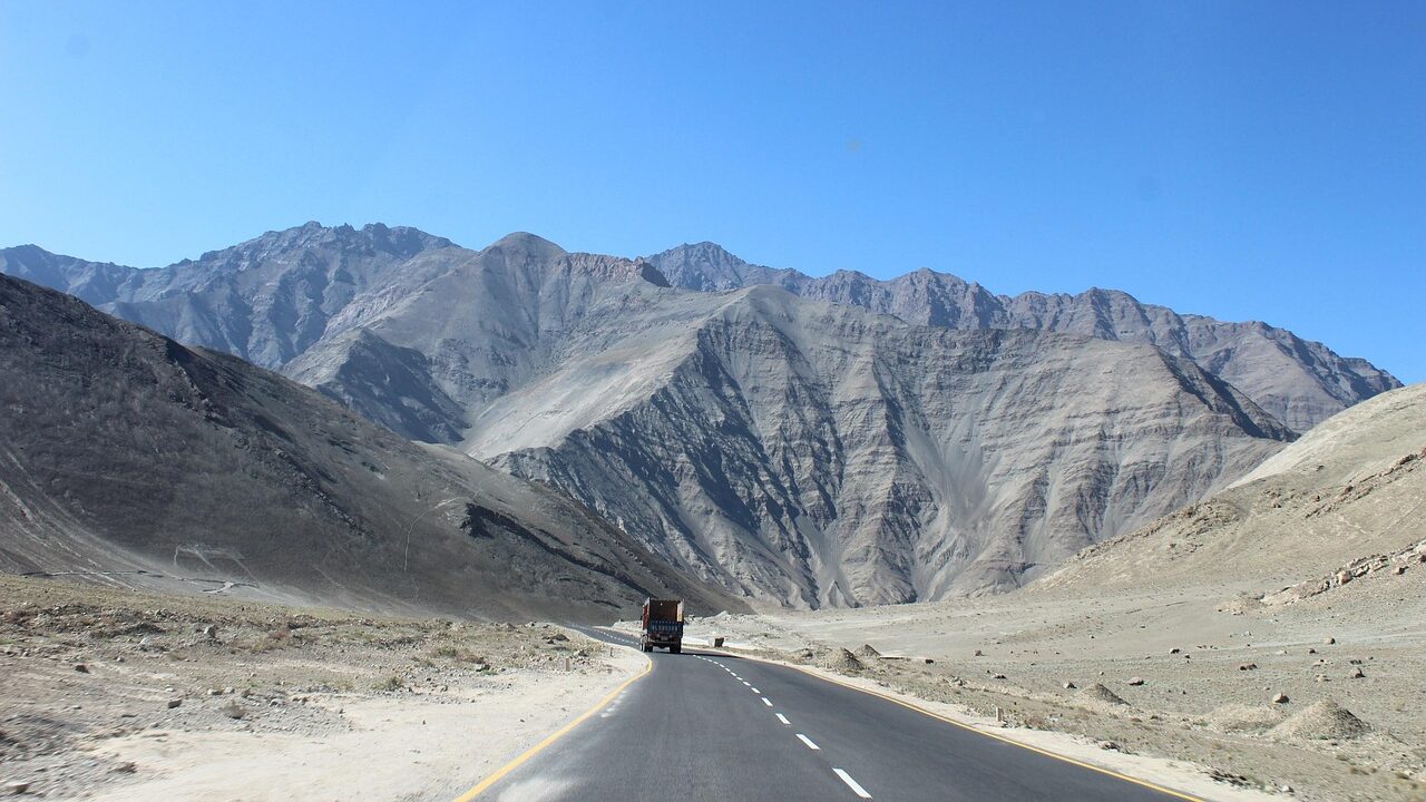 Endless winding roads cutting through the majestic mountains of Leh Ladakh, offering breathtaking views.